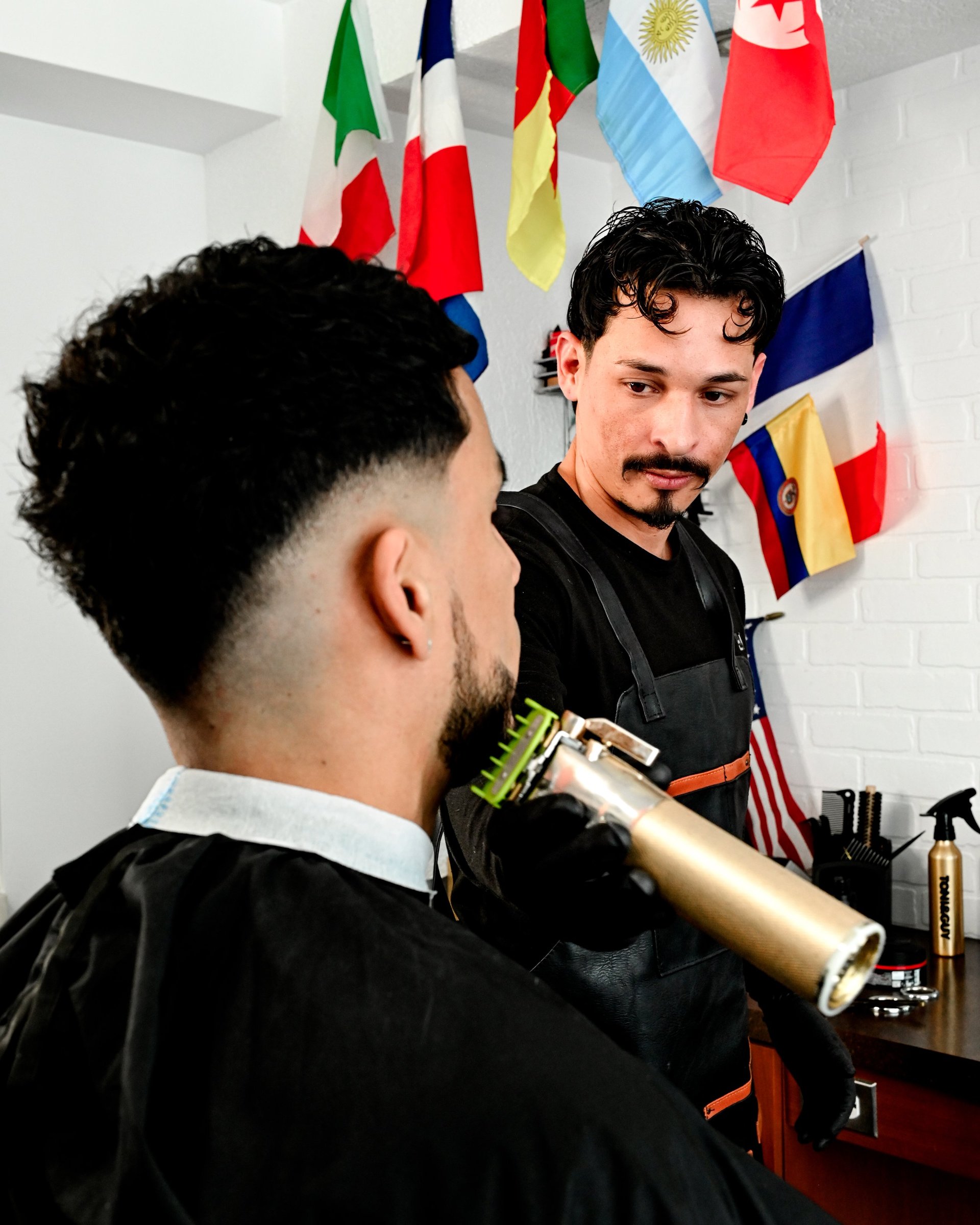 Barber trimming customers hair